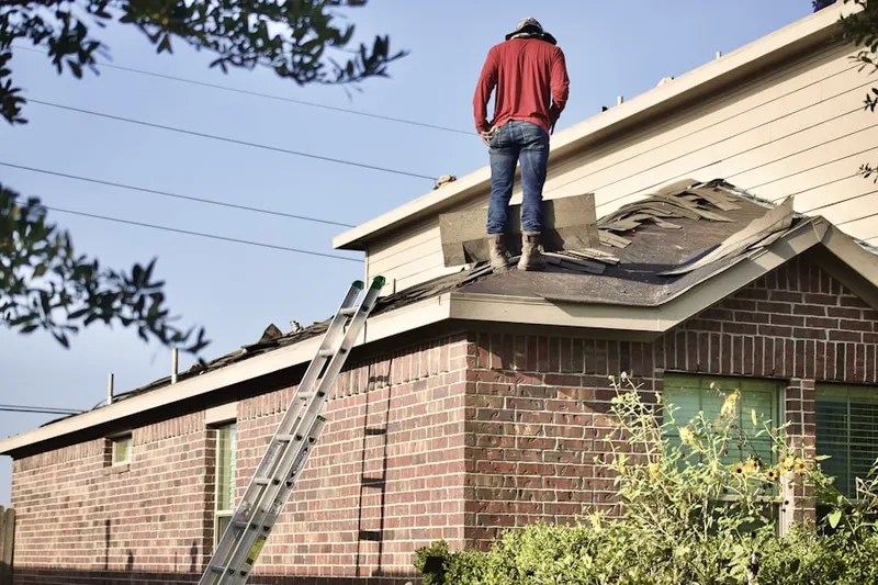 Professional roofer working on a residential roof in Meadowcreek